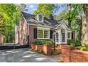 Beautiful brick home with black shutters, dormers and gated driveway at 277 Alberta Ne Dr, Atlanta, GA 30305