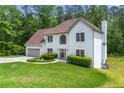 Stucco home with an attached two-car garage and a beautifully manicured lawn at 3060 Robertswood Dr, Powder Springs, GA 30127