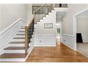 Elegant foyer with hardwood floors, staircase, and detailed molding at 3060 Robertswood Dr, Powder Springs, GA 30127