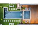Aerial view of a backyard with a large pool and spa surrounded by stylish lounge seating and lush landscaping at 3740 Powers Ferry Nw Rd, Atlanta, GA 30342
