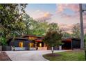 Charming home with manicured lawn, mature trees and a modern driveway leading to a covered carport at 3740 Powers Ferry Nw Rd, Atlanta, GA 30342