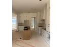 Open-concept kitchen design with white cabinetry, central island, and ample space for cooking and entertaining at 933 Mount Carmel Church Ln, Canton, GA 30114
