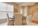 Eat in kitchen and dining area with a modern table set, light walls, and lots of light at 1295 Kilmington Ct, Alpharetta, GA 30009