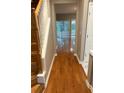 Welcoming entryway with gleaming hardwood floors, staircase, neutral paint, and a view of the outdoors at 1295 Kilmington Ct, Alpharetta, GA 30009