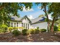 Lovely single-story home with lush landscaping, accentuating its architectural features at 401 Azalea Cv, Canton, GA 30114