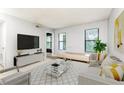 Bright living room with large windows, plush seating, and contemporary decor for a relaxing atmosphere at 1818 Huntingdon Chase, Atlanta, GA 30350