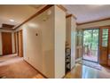 Hallway with hardwood floors, neutral walls, and elegant trim, leading to the front door at 3311 Creek Hollow Dr, Marietta, GA 30062