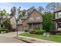 Charming brick home with an attached two-car garage and a meticulously maintained front yard and landscaping at 436 Barnett St, Woodstock, GA 30188