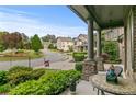 Inviting front porch with decorative columns and furnishings, offering a relaxing outdoor space overlooking the neighborhood at 436 Barnett St, Woodstock, GA 30188