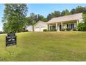 Landscaped front yard and well-maintained lawn with a for sale sign in view at 47 Cliff Ct, Villa Rica, GA 30180