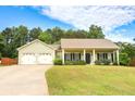 Well-kept home with a two-car garage, neutral paint, and a neatly manicured lawn at 47 Cliff Ct, Villa Rica, GA 30180