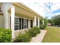 Inviting front porch with white columns and manicured shrubs, creating curb appeal at 47 Cliff Ct, Villa Rica, GA 30180