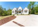 Exterior of a beautiful white brick home featuring a long driveway with fresh mulch landscaping at 541 Londonberry Rd, Atlanta, GA 30327