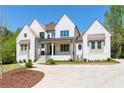 Beautiful exterior of a white brick home, featuring a well manicured lawn and fresh mulch at 541 Londonberry Rd, Atlanta, GA 30327