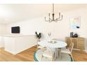 Bright dining area featuring a round table, stylish chandelier, and wood floors at 6109 Park Ave, Atlanta, GA 30342