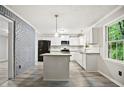 Modern kitchen with white cabinets, granite countertops, an island and stainless steel appliances at 6549 Biscayne Way, Douglasville, GA 30135