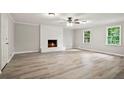 Open living room features sleek floors, a fireplace, and large windows offering ample natural light at 6549 Biscayne Way, Douglasville, GA 30135