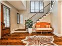 Elegant foyer showcasing wood floors, staircase with iron railing, and a stylish zebra print rug at 171 Beverly Ne Rd, Atlanta, GA 30309