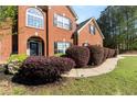 Beautiful brick home with a manicured lawn and landscaping at 1905 Buford Ct, Conyers, GA 30094