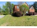 Charming brick home with a well-manicured lawn and mature landscaping at 1905 Buford Ct, Conyers, GA 30094