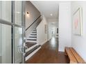 Bright entryway with hardwood floors, staircase with dark treads, and tasteful decor leading into the home at 4046 Hazel Nut Ln, Atlanta, GA 30342