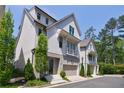 A modern two-story home boasting white siding, a gray foundation, and a conveniently attached one car garage at 4046 Hazel Nut Ln, Atlanta, GA 30342