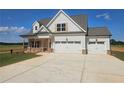 Charming two-story home with a three car garage, covered porch and manicured lawn at 1482 Alcovy Station Rd, Covington, GA 30014