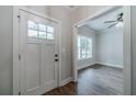 Inviting foyer with wood-look flooring, a white door, and an entryway to a naturally lit living space at 1482 Alcovy Station Rd, Covington, GA 30014