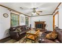 Cozy living room with a brick fireplace, wood trim, and plush leather furniture, creating a warm and inviting atmosphere at 309 Carmen Ct, Lawrenceville, GA 30046
