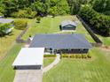 Charming single-story home with a well-maintained yard, detached garage, and a covered carport at 3872 Francis Dr, Powder Springs, GA 30127