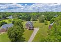 Sprawling property with a two-story brick home, large yard, and mature trees at 3135 Castlewood Dr, Loganville, GA 30052