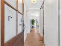 Bright entryway featuring hardwood floors, a glass-paneled door, and a modern coat rack and decor at 4304 Lake Laurel Se Dr, Smyrna, GA 30082