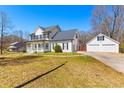 Charming two-story home with a welcoming front porch and a detached two-car garage at 821 Hood Rd, Fayetteville, GA 30214