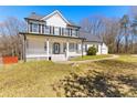 Charming two-story home with a welcoming front porch and a detached two-car garage at 821 Hood Rd, Fayetteville, GA 30214