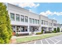 Stylish two-story townhome featuring covered patios and lush landscaping in a well maintained community at 212 Sessions St, Woodstock, GA 30188