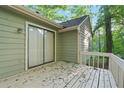 View of an exterior deck overlooking the yard, accessed by a sliding glass door at 5248 Martins Crossing Rd, Stone Mountain, GA 30088