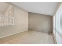 Bright living room with wood-look flooring, a vaulted ceiling, and a stylish wood accent wall at 5248 Martins Crossing Rd, Stone Mountain, GA 30088