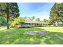 Beautiful one-story brick house with a well-maintained lawn, mature trees, and ample space at 5327 David Cir, Covington, GA 30014