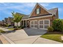 Beautiful brick home with a well-maintained lawn and a two-car garage, set against a sunny sky at 5850 Overlook Rdg, Suwanee, GA 30024