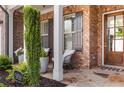 Inviting front porch with seating, showcasing the home's brick facade and well-maintained landscaping at 5850 Overlook Rdg, Suwanee, GA 30024