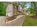 Split-level home with an attached two-car garage, a sidewalk, and landscaped yard at 685 Maplelake Dr, Acworth, GA 30101