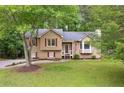 Charming split-level home featuring red shutters, a well-maintained lawn, and mature trees at 685 Maplelake Dr, Acworth, GA 30101