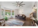 Bright living room with large windows, hardwood floors, and a comfortable sofa at 685 Maplelake Dr, Acworth, GA 30101