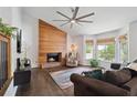 Bright living room with a wood accent wall, fireplace, and a bay window at 685 Maplelake Dr, Acworth, GA 30101