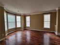 Inviting living room featuring gleaming hardwood floors, large windows, and abundant natural light at 1745 Collines Sw Ave, Atlanta, GA 30331