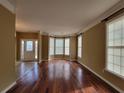 Inviting living room featuring gleaming hardwood floors, large windows, and abundant natural light at 1745 Collines Sw Ave, Atlanta, GA 30331