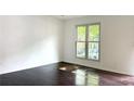 Sunlit bedroom with gleaming wood floors and a large window providing ample natural light at 1807 Queen Anne Ct, Sandy Springs, GA 30350