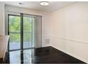Dining area features wood floors, slider to deck, and wainscoting at 1807 Queen Anne Ct, Sandy Springs, GA 30350
