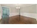 Dining room featuring hardwood floors, chair rail, and modern chandelier at 2068 Signal Ridge Nw, Kennesaw, GA 30152