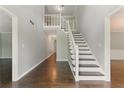 Bright foyer with wood floors, white staircase, and natural light at 2068 Signal Ridge Nw, Kennesaw, GA 30152